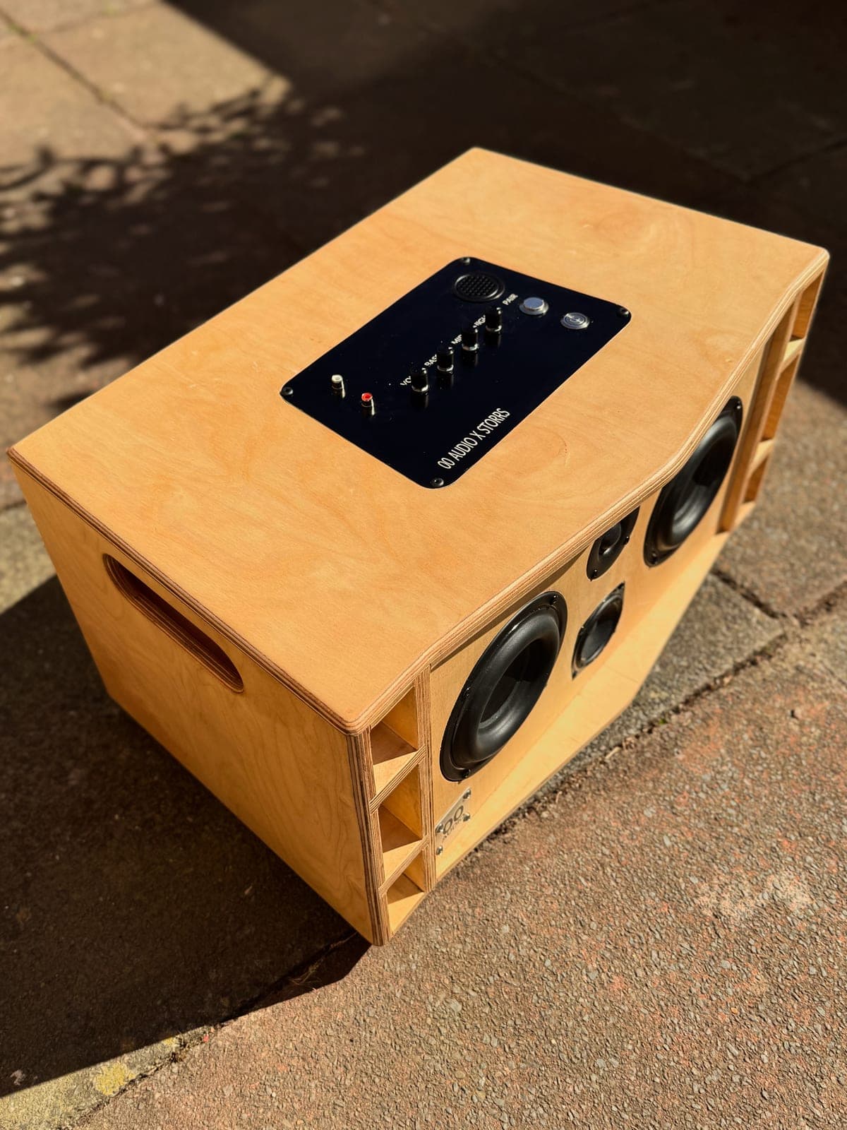 Custom laser-engraved 00 Audio × Storrs top plate with tone controls