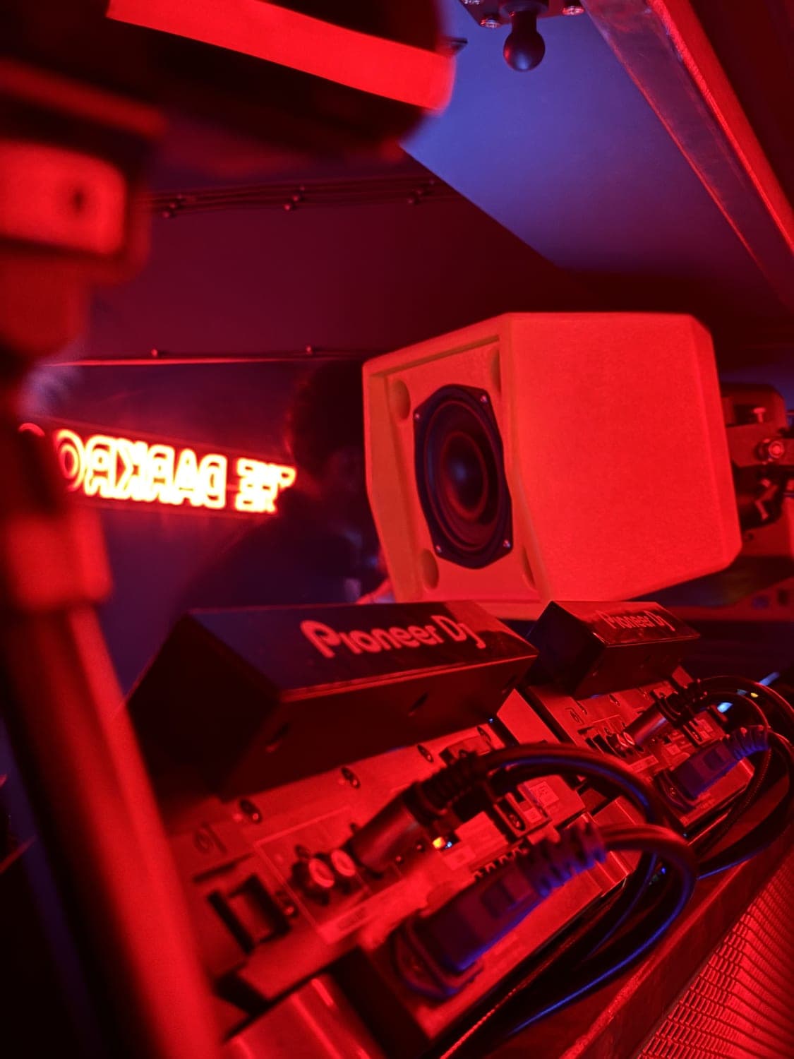 Booth monitor mounted in The Darkroom beside the neon sign
